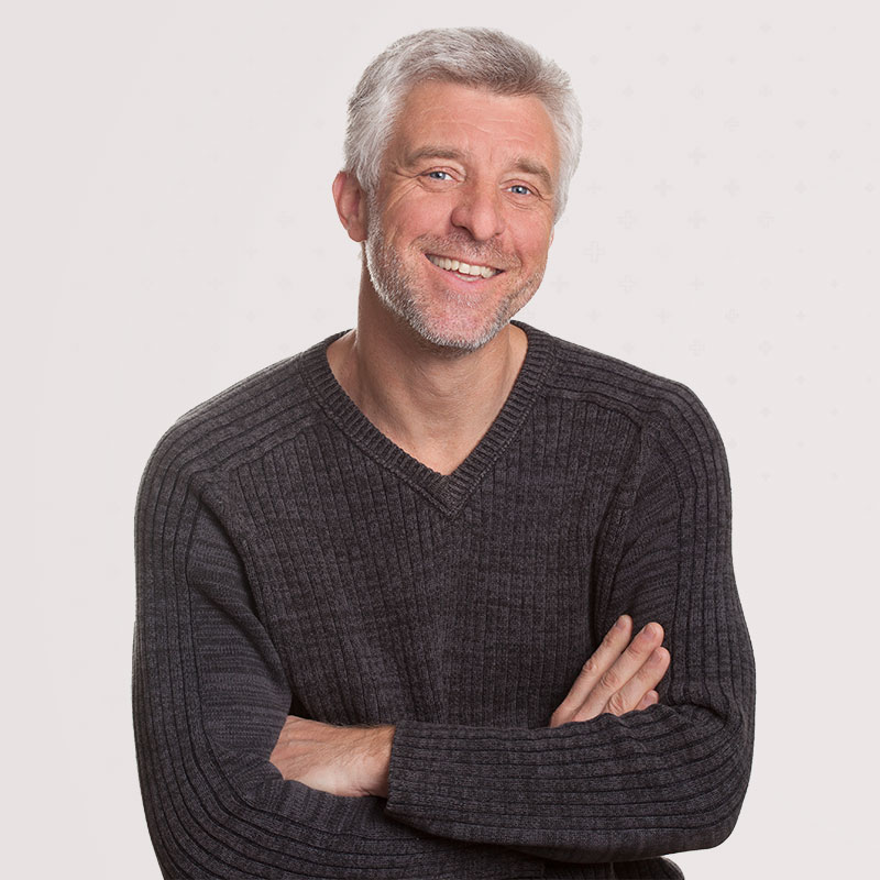 Smiling middle-aged man after successful core strength recovery with The Tummy Team’s functional core rehab program.